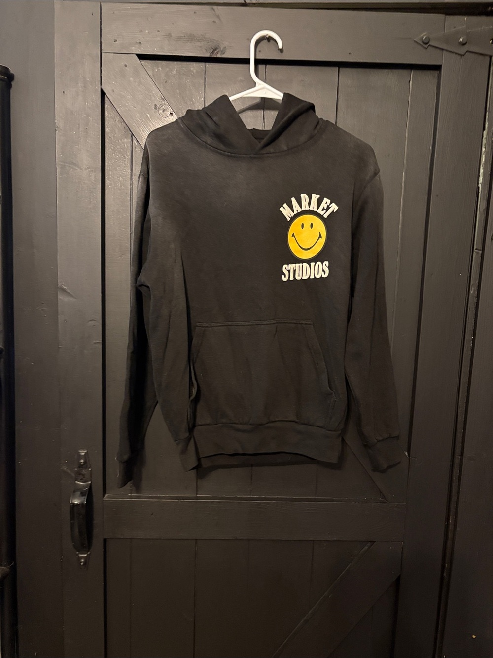 Black Hoodie with Yellow Smiley Graphic